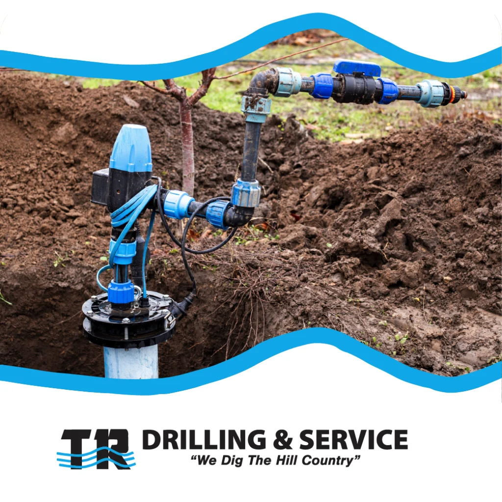 Blue well pump and piping system set in a freshly dug trench with branding from TR Drilling & Service